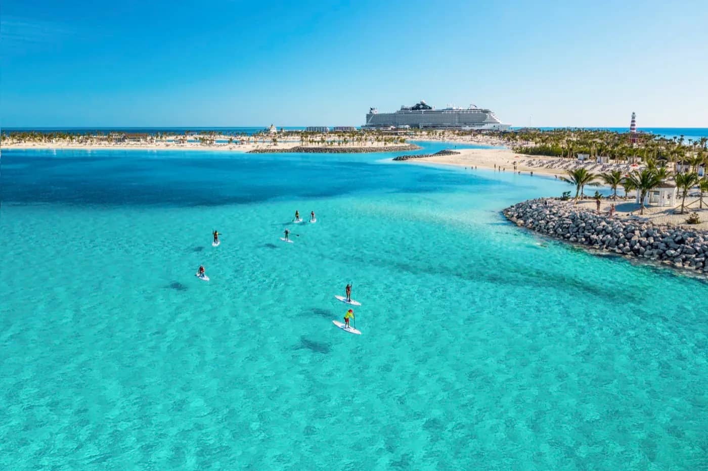 Paddleboarders in a turquoise lagoon at Ocean Cay in the Bahamas